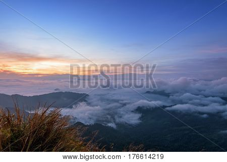 Beautiful landscape nature sunrise on peak mountain with sun cloud fog and bright colors of sky in winter at Phu Chi Fa Forest Park is a famous tourist attraction of Chiang Rai Province Thailand