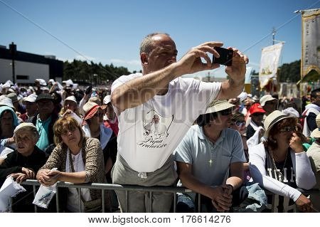 Fatima Portugal - May 13 2014: Crowd of people at the Sanctuary of Fatima during the celebrations of the apparition of the Virgin Mary in Fatima Portugal.