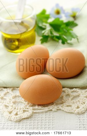 Fresh Eggs with Olive Oil on Table