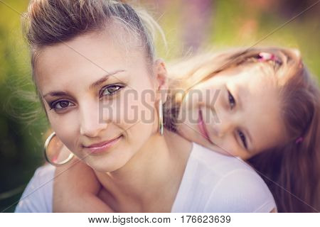 Summer portrait of hugging mother and daughter