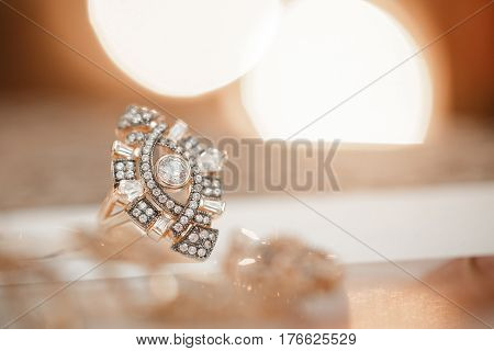 beautiful gold ring with a diamond on a soft beige background