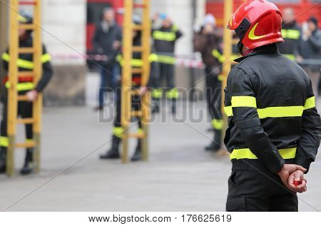 Firemen During Rescue Operations With A Wooden Ladder