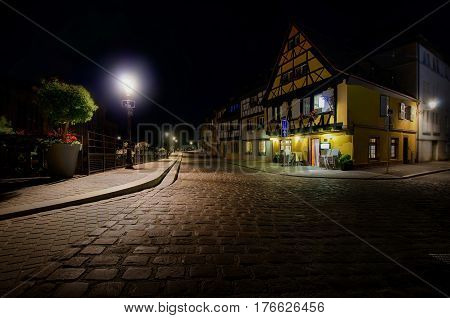 Embankment of fish-traders in Colmar city, Alsace,  France at night. Street lights are burning.