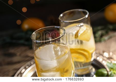Glasses with delicious wine spritzer on dark background