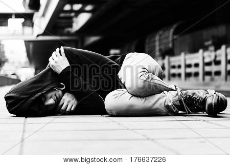 Young man homeless sleep on the street