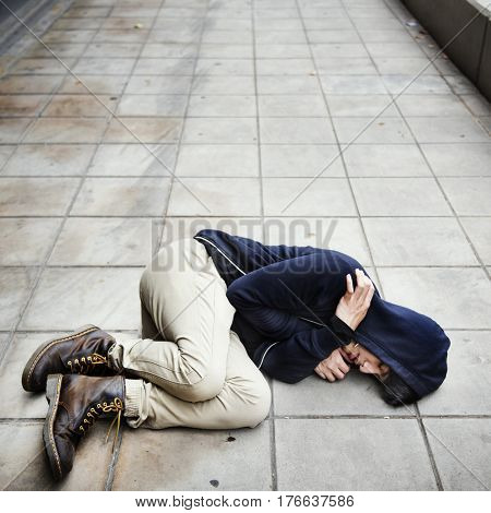 Young man homeless sleep on the street