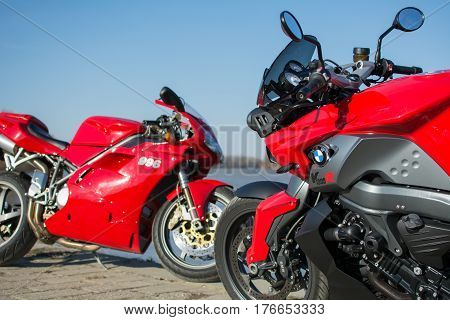Senta Serbia: March 4th 2017. Closeup of beautiful red Ducati 996s and BMW K1300R motorcycles photographed outdoor on a dock in Senta besides beautiful river Tisa