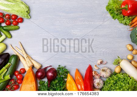 Vegetables. Tomato, cucumber and carrot. Celery, zucchini and eggplant. Potatoes, onion and garlic. Pepper, brocoli and salad, squash. Pumpkin and parsley. Organic food on wooden table.