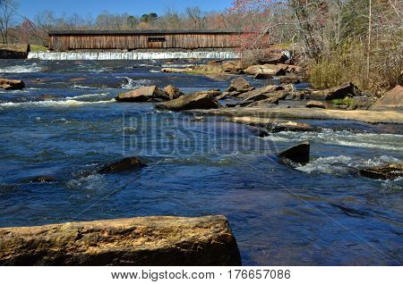 Rocky waters along the covered bridge at Watson Mill State Park in Comer, Georgia