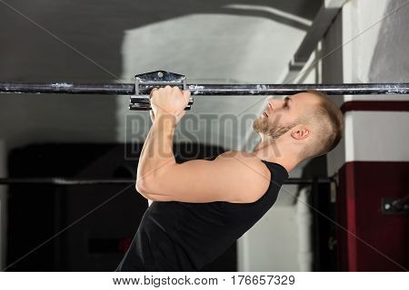 Close-up Of An Athlete Man Doing Narrow Grip Pullup Exercise In The Gym