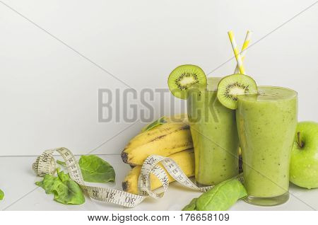 Fresh and healthy green smoothie with spinach,banana, kiwi and apple. Picture with space for text or logo