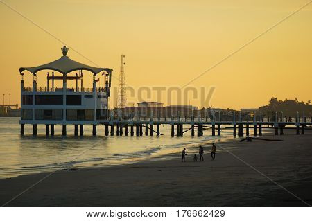 Labuan,Malaysia-Mac 15,2017:View of Manja Rasa floating restaurant during sunset with silhouette of people in the beach in Labuan island,Malaysia.