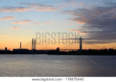 Cable stayed bridge and Neva river on the outskirts of St. Petersburg at sunset Russia.