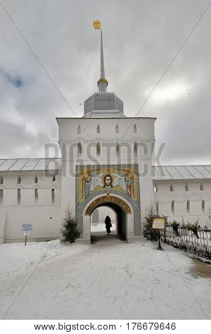 Tolga Convent in Yaroslavl. The tower at the entrance to the monastery. In the arch you can see the silhouette of a woman. Gold ring. Russia. Winter.