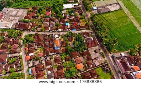 Beautiful landscape with balinese village and rice fields, Bali, Indonesia. Aerial view.