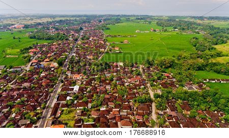 Beautiful landscape with balinese village and rice fields, Bali, Indonesia. Aerial view.