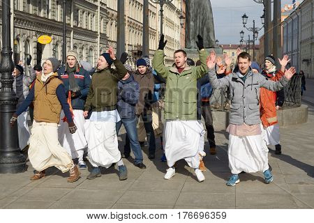 12.03.2017.Russia.Saint-Petersburg.On the street gathered followers of Lord Krishna.Young people are dancingcollecting alms and distributing sweets.
