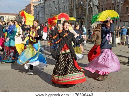 12.03.2017.Russia.Saint-Petersburg.On the street gathered followers of Lord Krishna.Young people are dancingcollecting alms and distributing sweets.