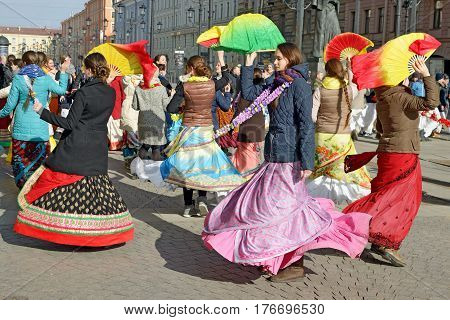 12.03.2017.Russia.Saint-Petersburg.On the street gathered followers of Lord Krishna.Young people are dancingcollecting alms and distributing sweets.