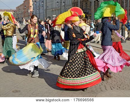 12.03.2017.Russia.Saint-Petersburg.On the street gathered followers of Lord Krishna.Young people are dancingcollecting alms and distributing sweets.