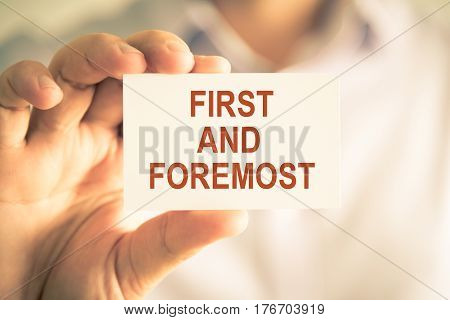 Businessman Holding First And Foremost Message Card