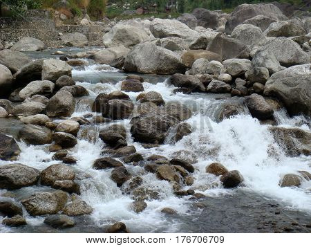 Rocks in force of white water rapids in river