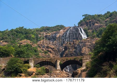 Dudhsagar waterfall and railroad bridge in Goa India