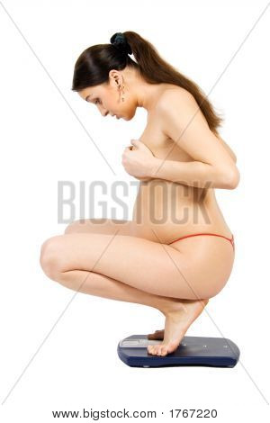 A Pregnant Woman Measuring Her Weigth