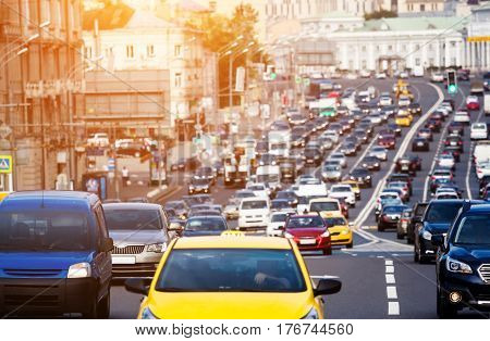 Heavy traffic on the city highway with yellow car on the front
