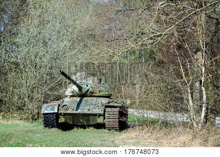 Battle tank in the moor of a forest