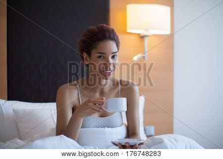 Young Happy Black Woman Sits In A Bed.