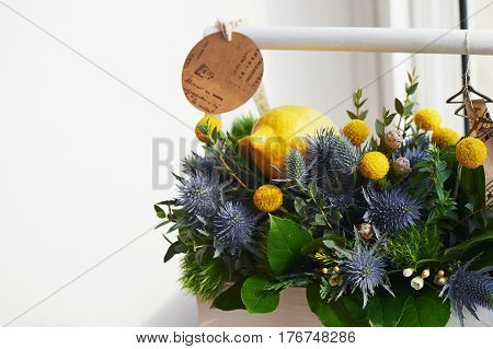 A spring bouquet in a white wooden box in the yellow-green spectrum. lemon.