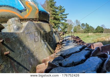 Battle tank in the moor of a forest