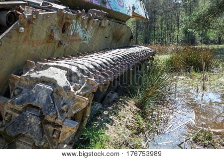 Battle tank in the moor of a forest