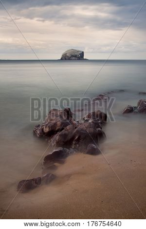 The Bass Rock is a distinctive island in the Firth of Forth, East Lothian, Scotland which has variously served as a hermitage for early Christians and a Covenanter prison in the 17th century. It is currently home to the largest colony of gannets in the wo
