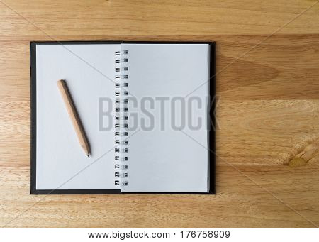 Top view of white book on wooden background