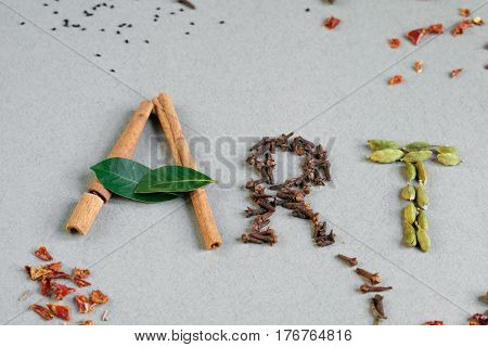 Word Art from green leaves and seasonings. Multicolor paint splash painted word art. White background top view