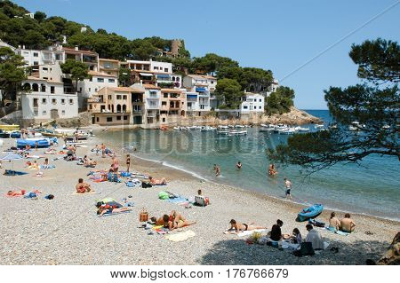 Sa Tuna (Begur) Spain - 12 July 2004: Tourists sunbathing and swimming at the beach of Sa Tuna on Costa Brava Spain