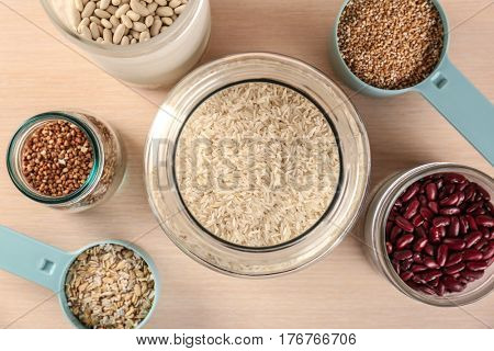 Kitchen containers with groceries on wooden table