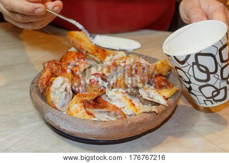 Woman In Kitchen With Roast Chicken. Woman Cooking in the kitchen