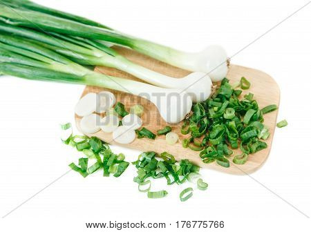 Cut green fresh onion on the wooden bord.Vegetables,vitamins.White isolated background.Top view