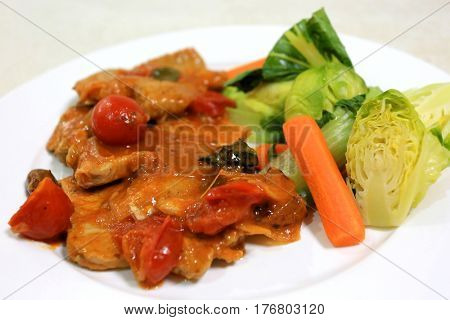 Italian style beef escalopes in a tomato, onion and olive sauce served with steamed vegetables