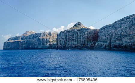 The rocky coast of the Mediterranean sea against the blue sky on a clear summer day