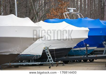 power and sail boat protected by shrink wrap