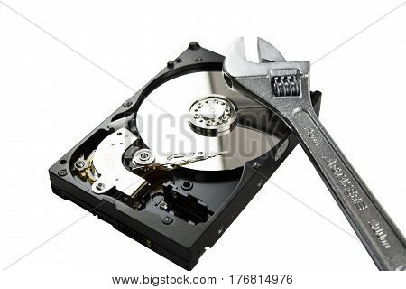 Disassembled Hard Disk without top cover. adjustable wrench on HDD. Computer hardware.