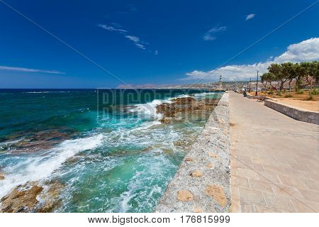 Chania, Crete, Greece - 26 June 2016:View on the Embankment near the Old Town of Chania and Chania Lighthouse on the summer sunny day. Embankmentis located near the Old Town of Chania and it is favorite place for tourists who are visiting and walking ther