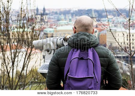 a tourist man is watching panorama in a European city
