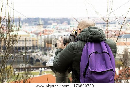 a tourist man is watching panorama in a European city