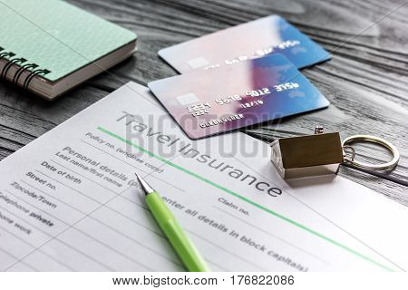 Travel preparation concept with insurance application form and credit cards for online payment on wooden table background