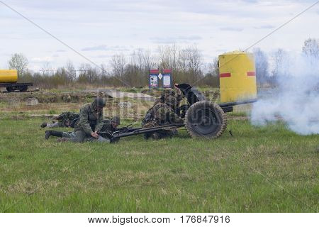 LENINGRAD REGION, RUSSIA - MAY 05, 2015: German soldiers firing from anti-tank guns. Reconstruction of the episode of the great Patriotic war